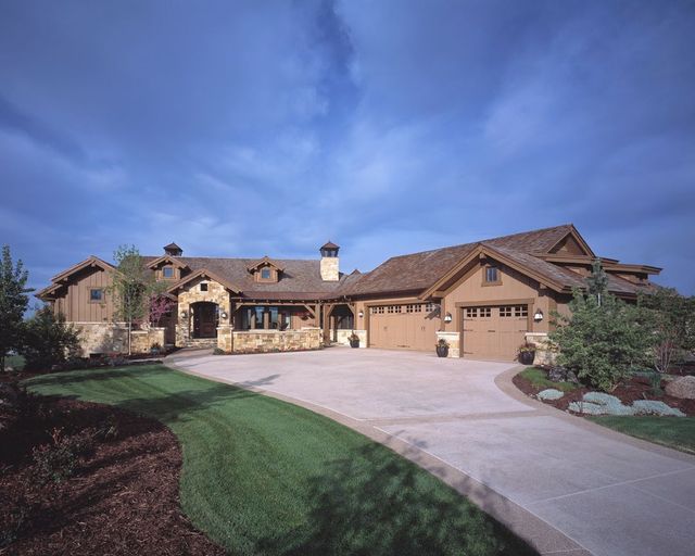 A large house with a driveway leading to it