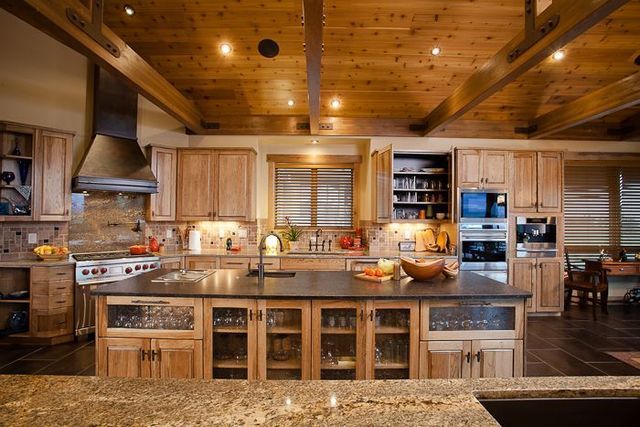 A kitchen with wooden cabinets and granite counter tops