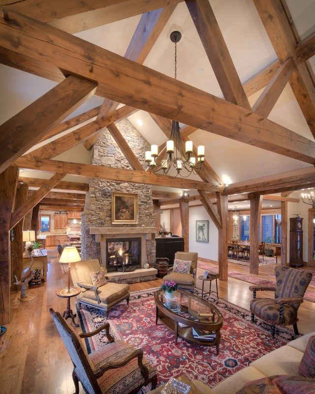 A living room with wooden beams and a fireplace