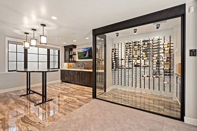A basement with a wine cellar and a table.