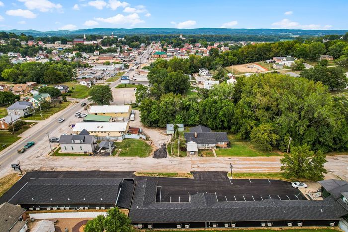 An aerial view of a small town with a large building in the middle.