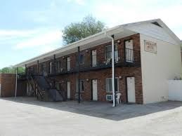 A small apartment building with stairs leading up to the second floor.