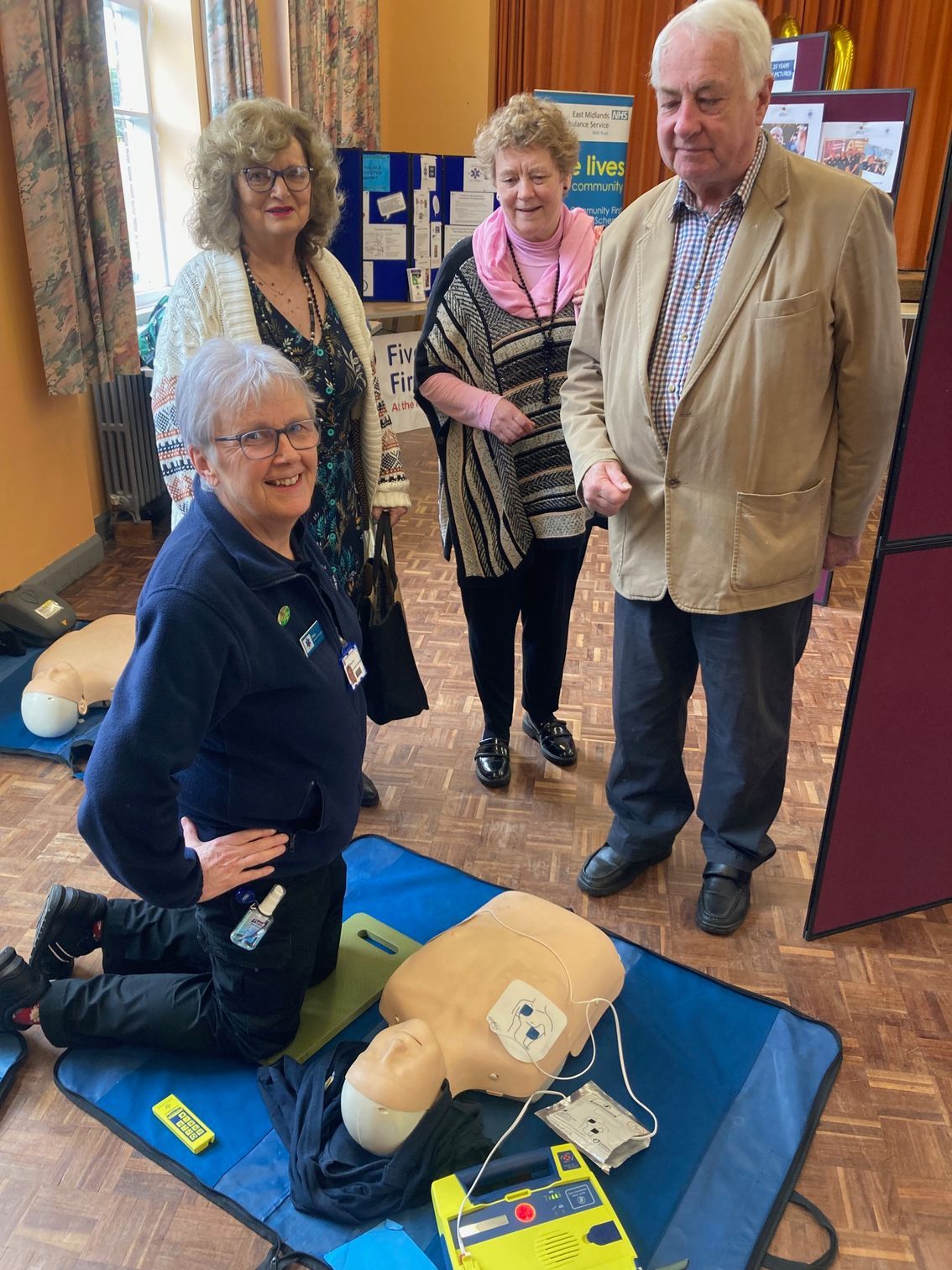 Community Responder, Mary Riches, shows members of the public including Cllr Hazel Brand, how to perform CPR and use a defibrillator.
