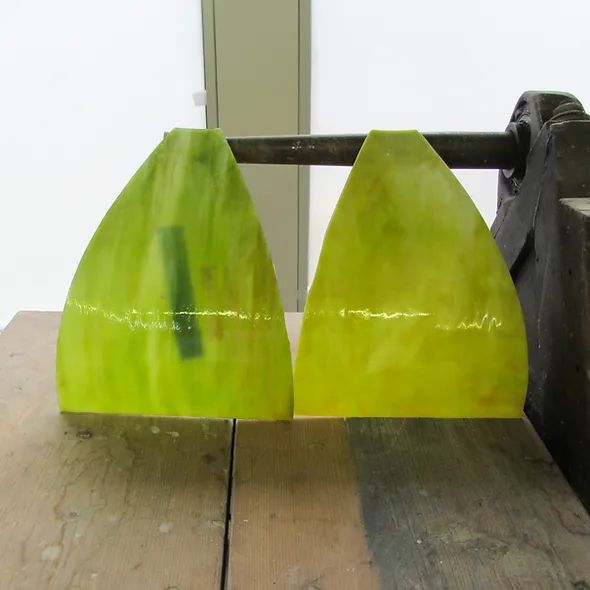 Two yellow triangles are sitting on a wooden table