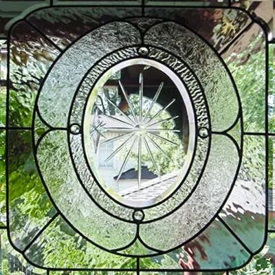 A stained glass window with a mirror in the middle