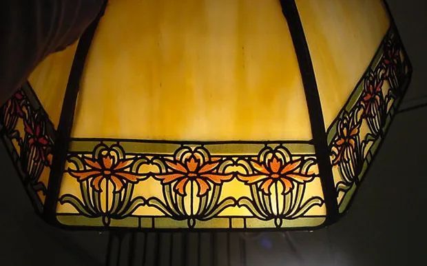 A stained glass lamp with flowers on it