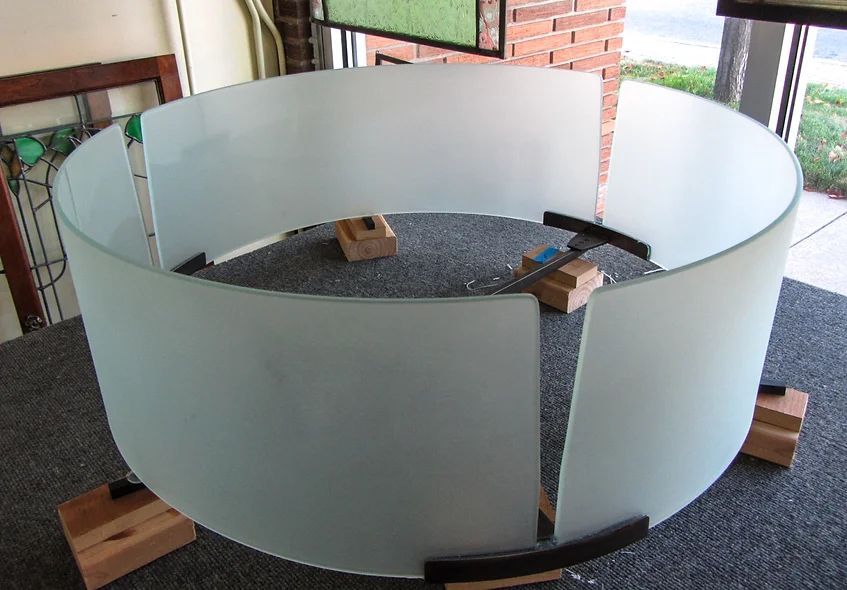 A round piece of glass is sitting on a table