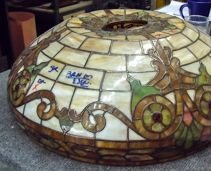 A stained glass lamp shade with the number 34 on it