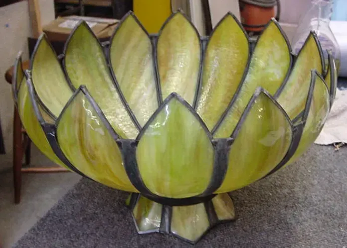A stained glass bowl in the shape of a lotus flower