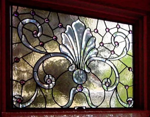 A stained glass window with a floral design on it