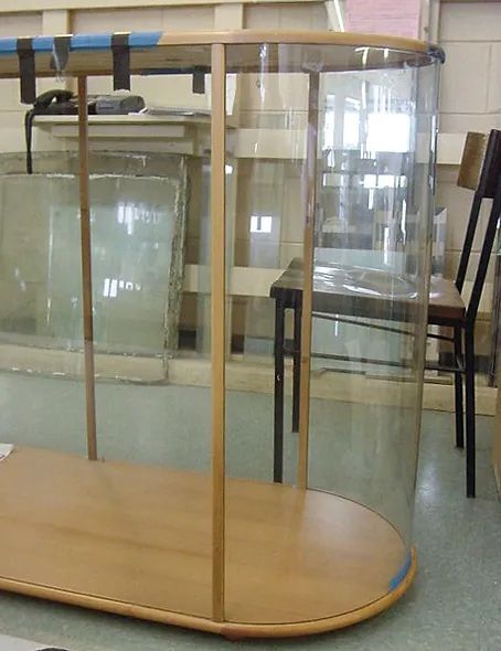 A glass display case with a wooden base
