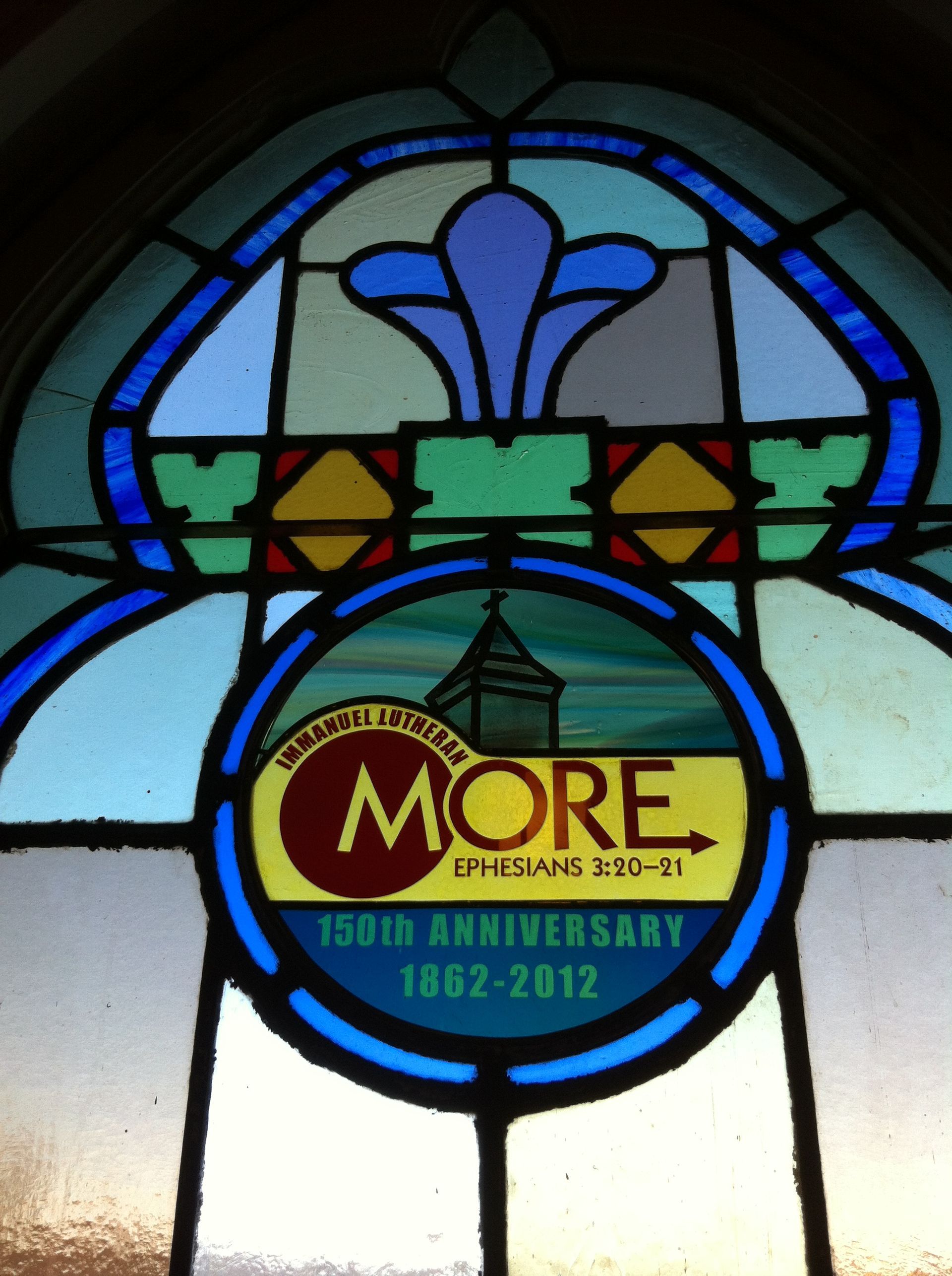 A stained glass window with the word more on it