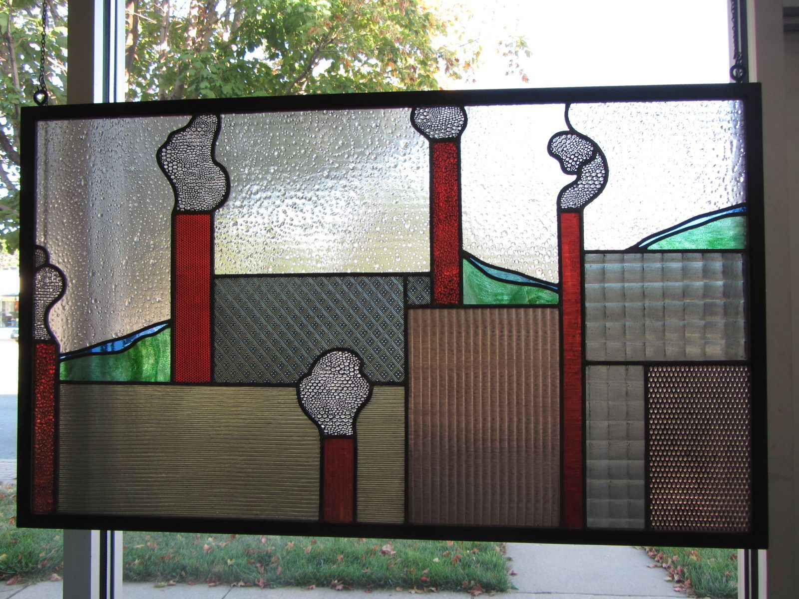 A stained glass window with chimneys on it