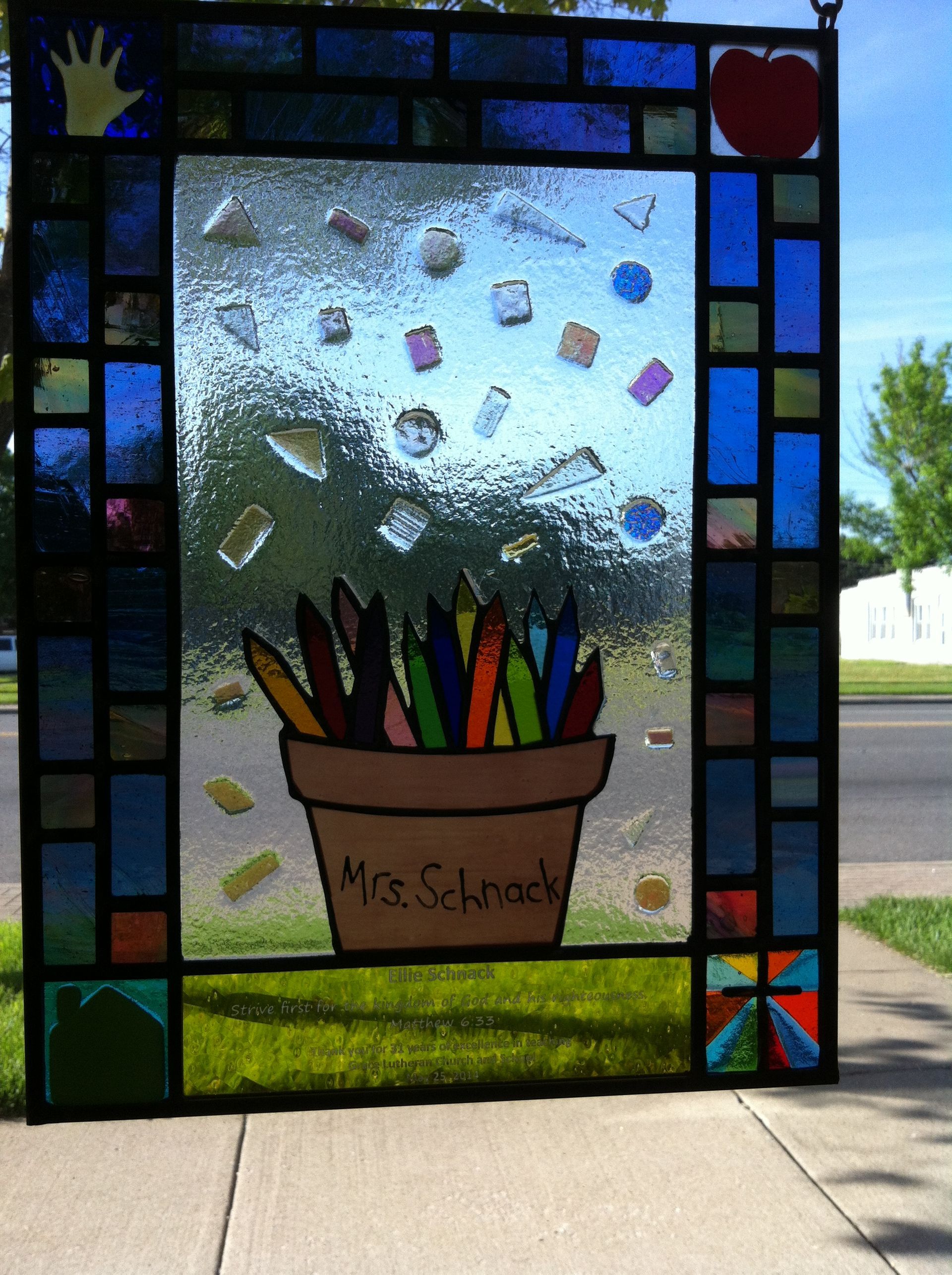 A stained glass window with the name mrs. schmidt on it