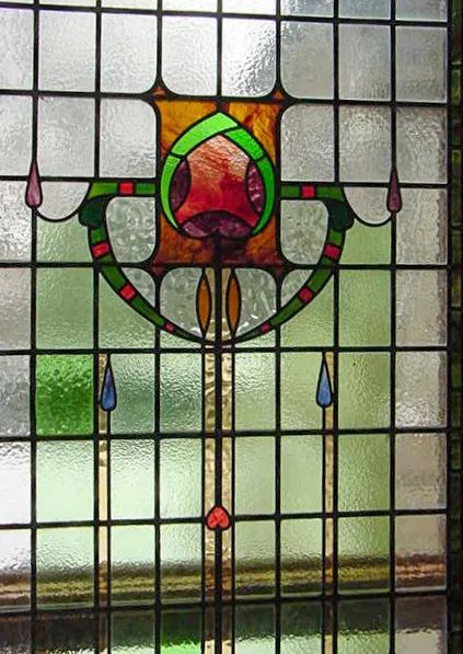A stained glass window with a flower design on it