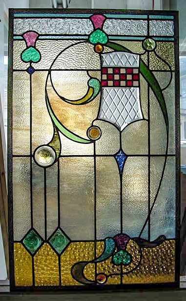 A stained glass window with a coat of arms on it.