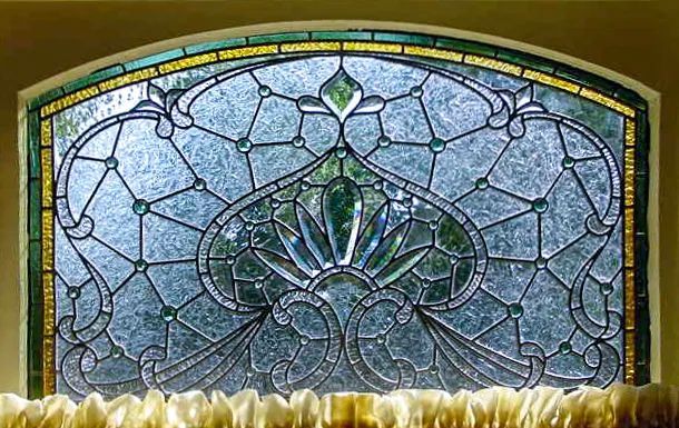 A stained glass window with a floral design on it