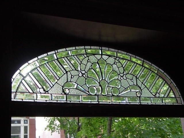 A stained glass window with a fan design on it