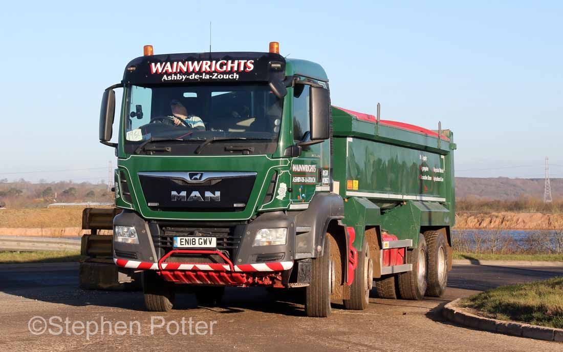 Blue Wainwight's DAF tipper truck on a road. Sunny day.