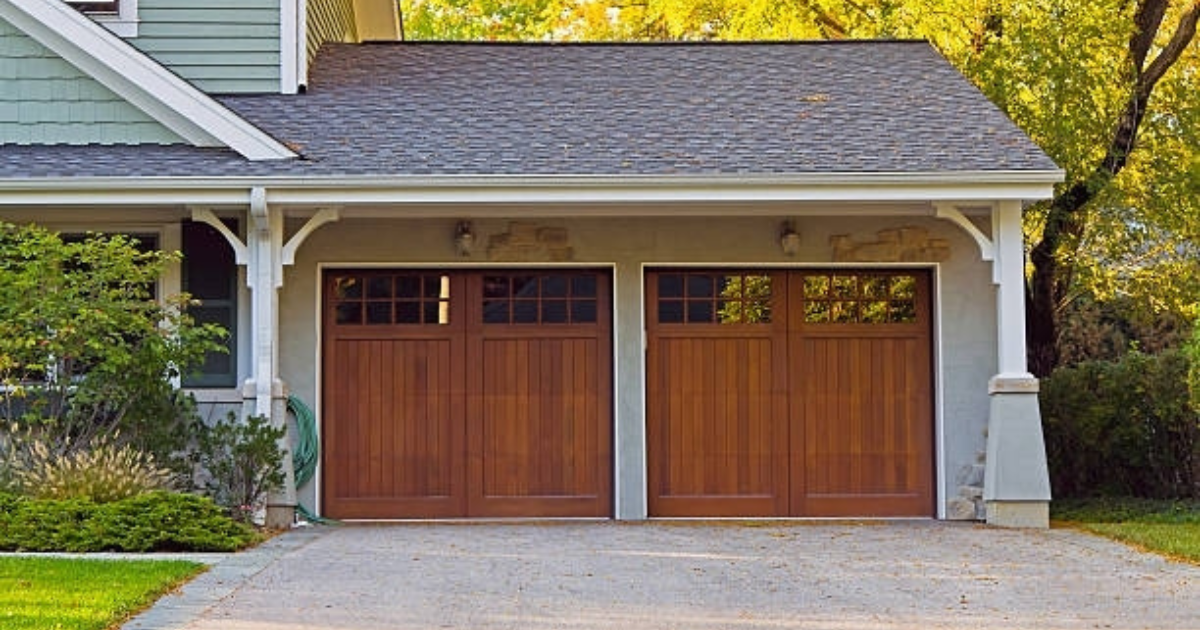 Natural wood carriage house garage doors designed for a two door garage displayed by Garage Tech of Bothell Washington