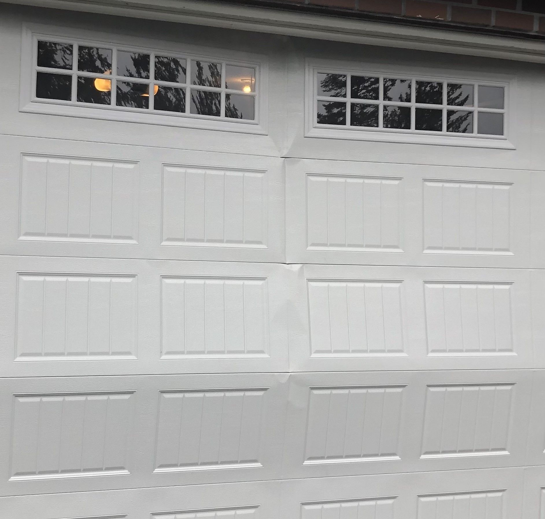 Garage Tech garage door service and repair for lightly damaged residential garage door serving Kenmore Washington