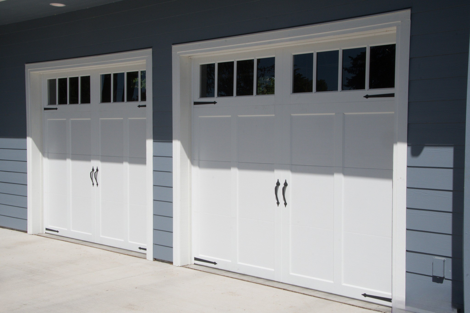 Wood carriage garage doors showcasing natural grain patterns by Garage Tech serving Kirkland, WA