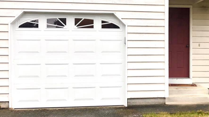 Traditional steel carriage house garage door for a single car garage displayed by Garage Tech of Bothell Washington