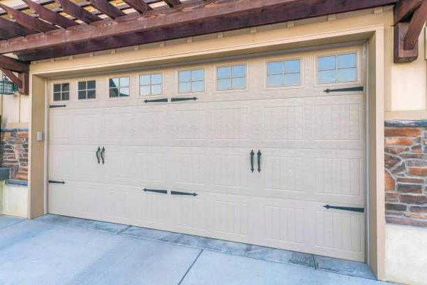 Carriage style steel garage doors with window accents by Garage Tech serving Everett, WA