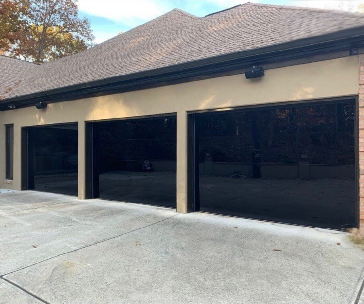 Modern garage doors with glass and metal accents by Garage Tech serving Kenmore, WA