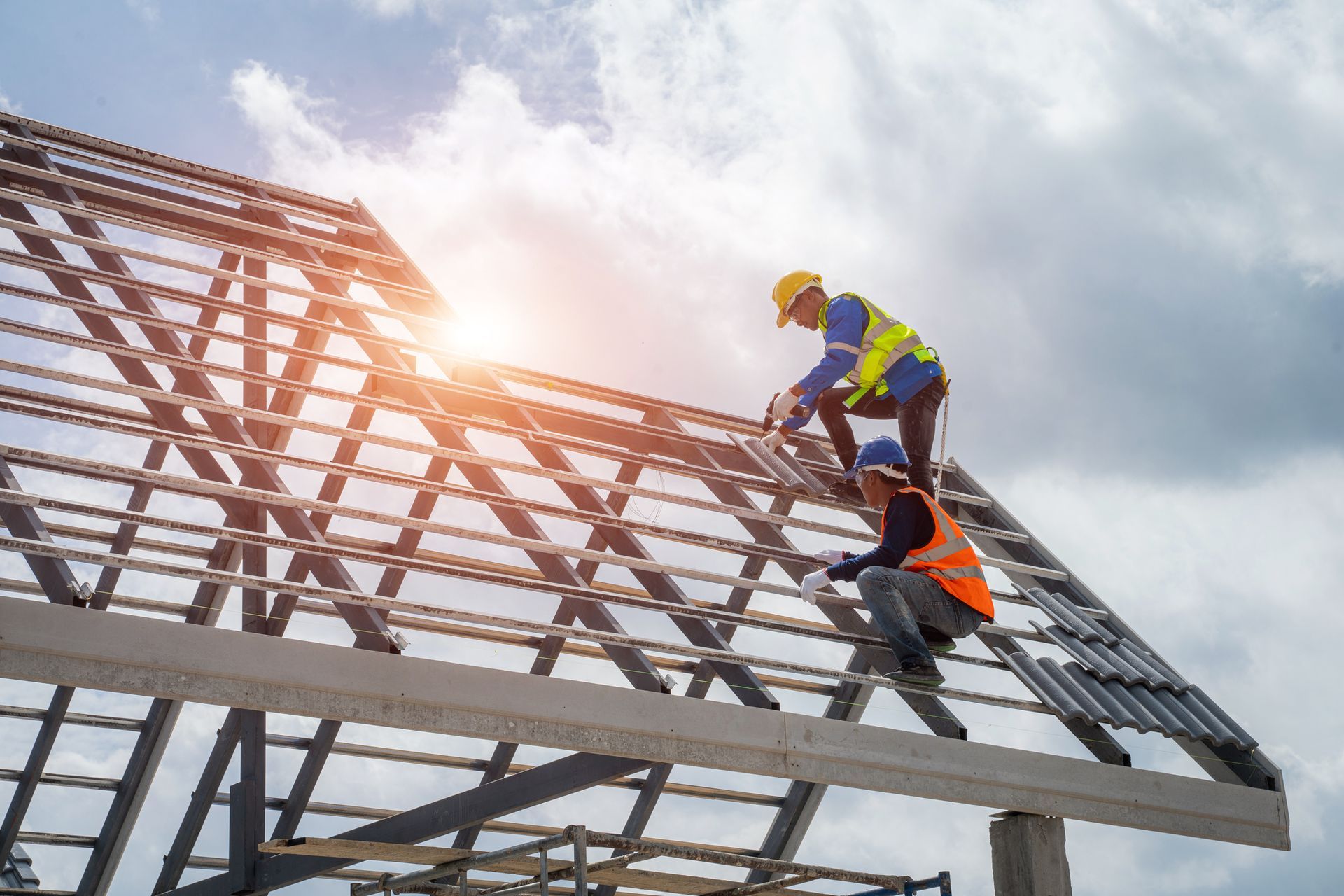 Roofers working on the roof structure of a business.
