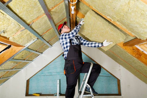 Man installing thermal roof insulation with mineral wool panels for attic renovation at Tracy's Insulation, Bremerton, WA - Full-Service Residential Insulation.