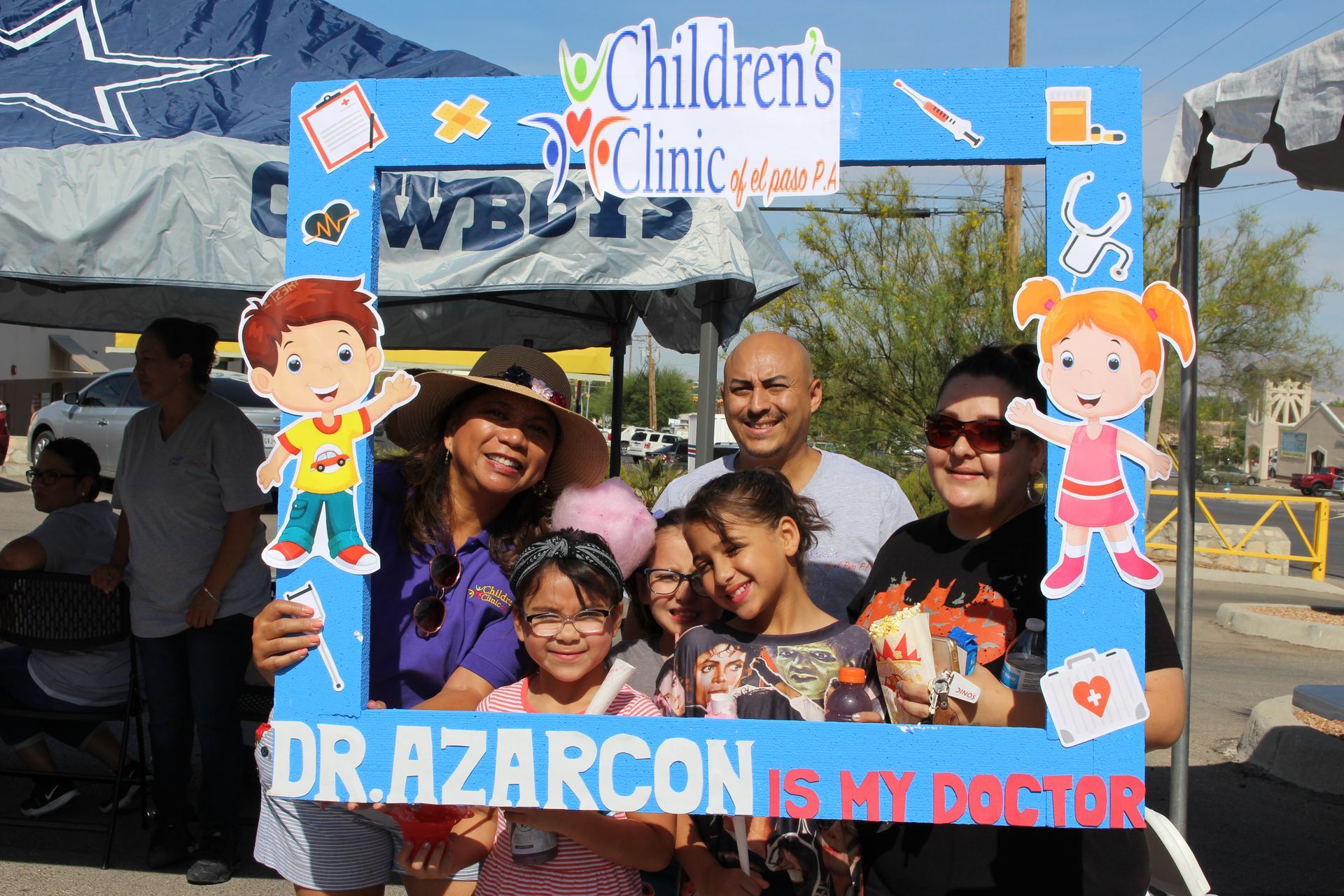 A group of people holding a picture frame that says children 's clinic