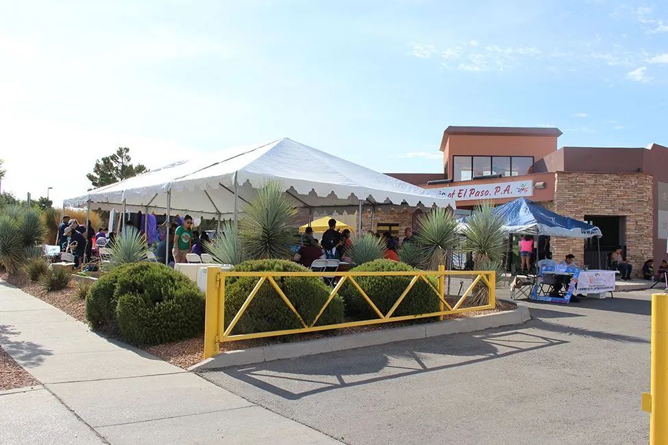 A white tent is set up in front of a building