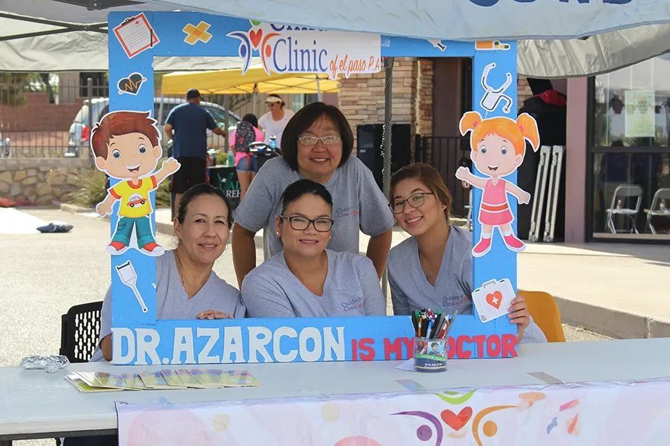 A group of women standing in front of a sign that says dr. azarcon is my doctor