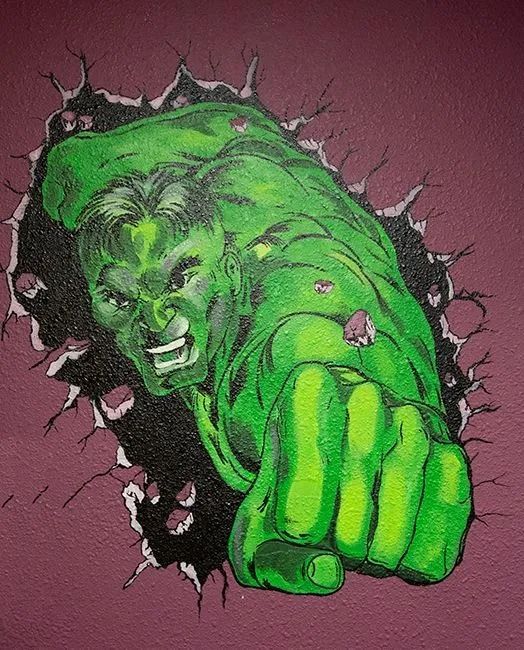 A painting of the hulk breaking through a wall