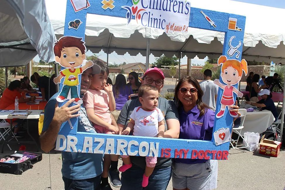 A group of people posing for a picture with a sign that says dr. azarcon is my doctor