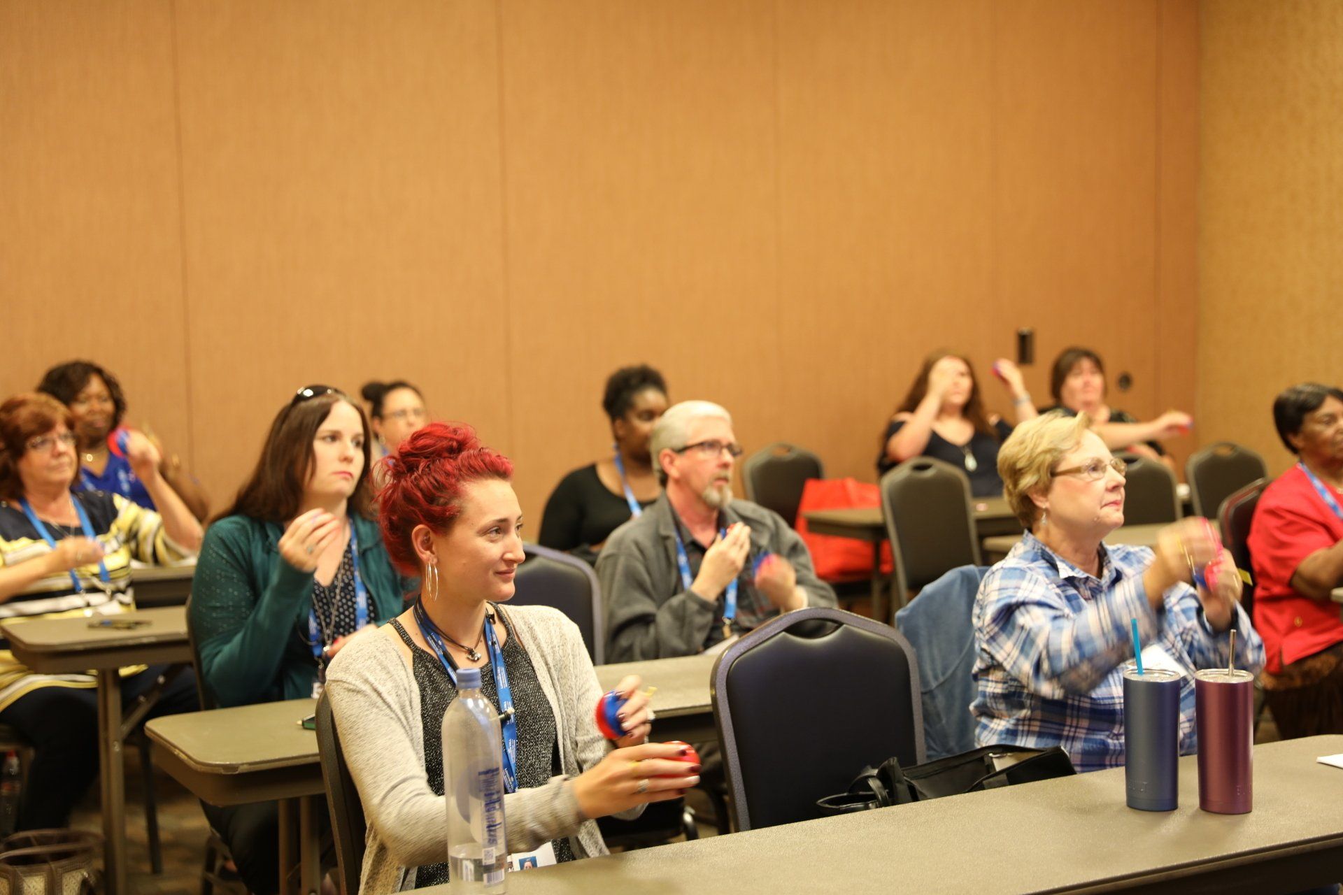 A group of people are sitting at tables in a room.