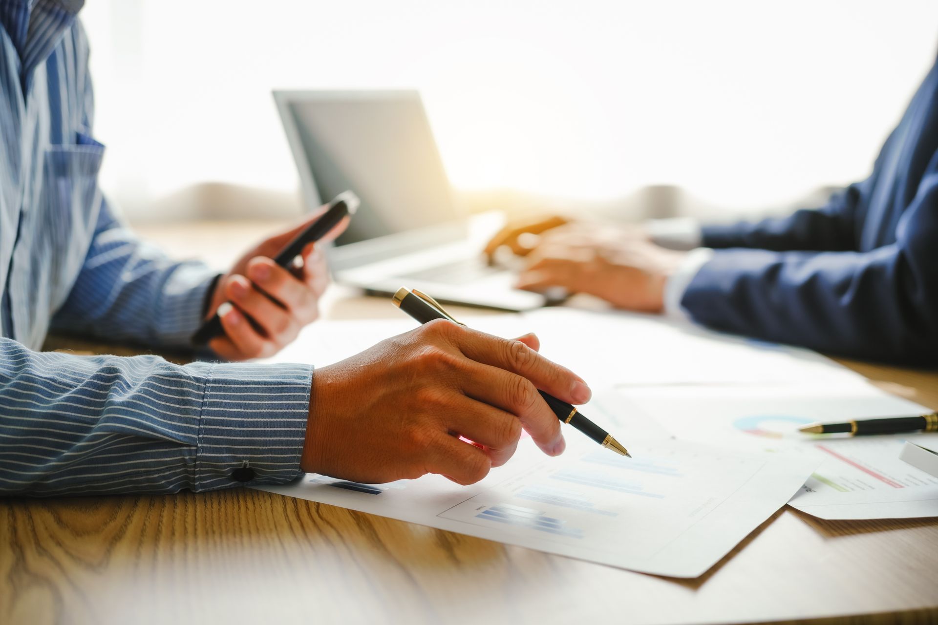 Two people reviewing documents at a table. 