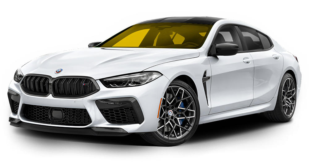 White BMW M8 Gran Coupe, black grille, yellow tinted windows, dark wheels.