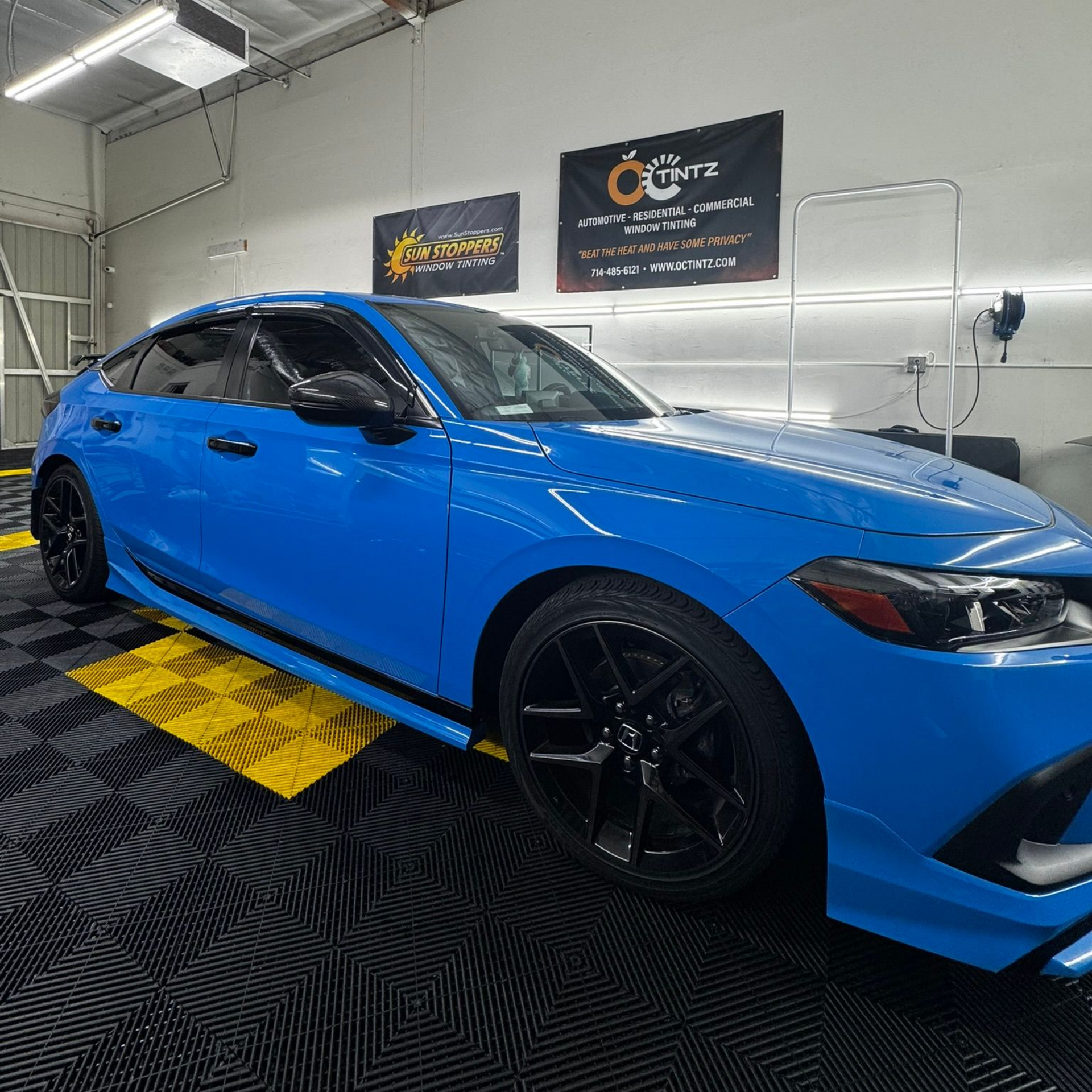 A white bmw i8 is parked in a grassy field at a car show.