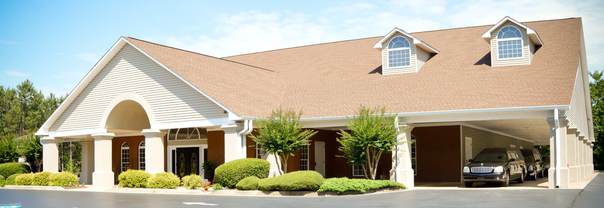 A large house with a car parked in front of it