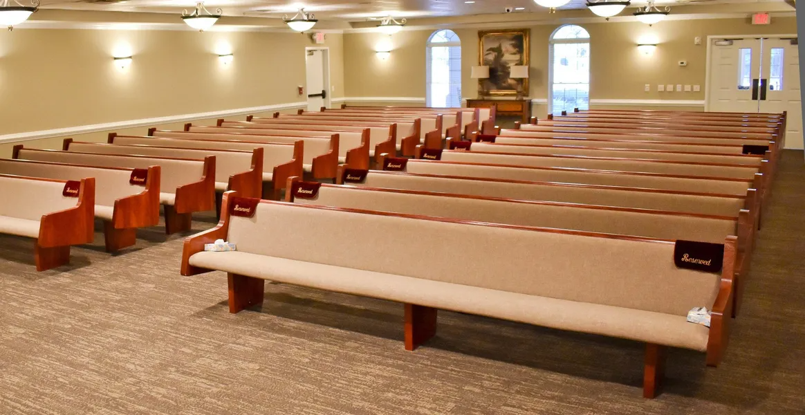 There are rows of benches in a church.