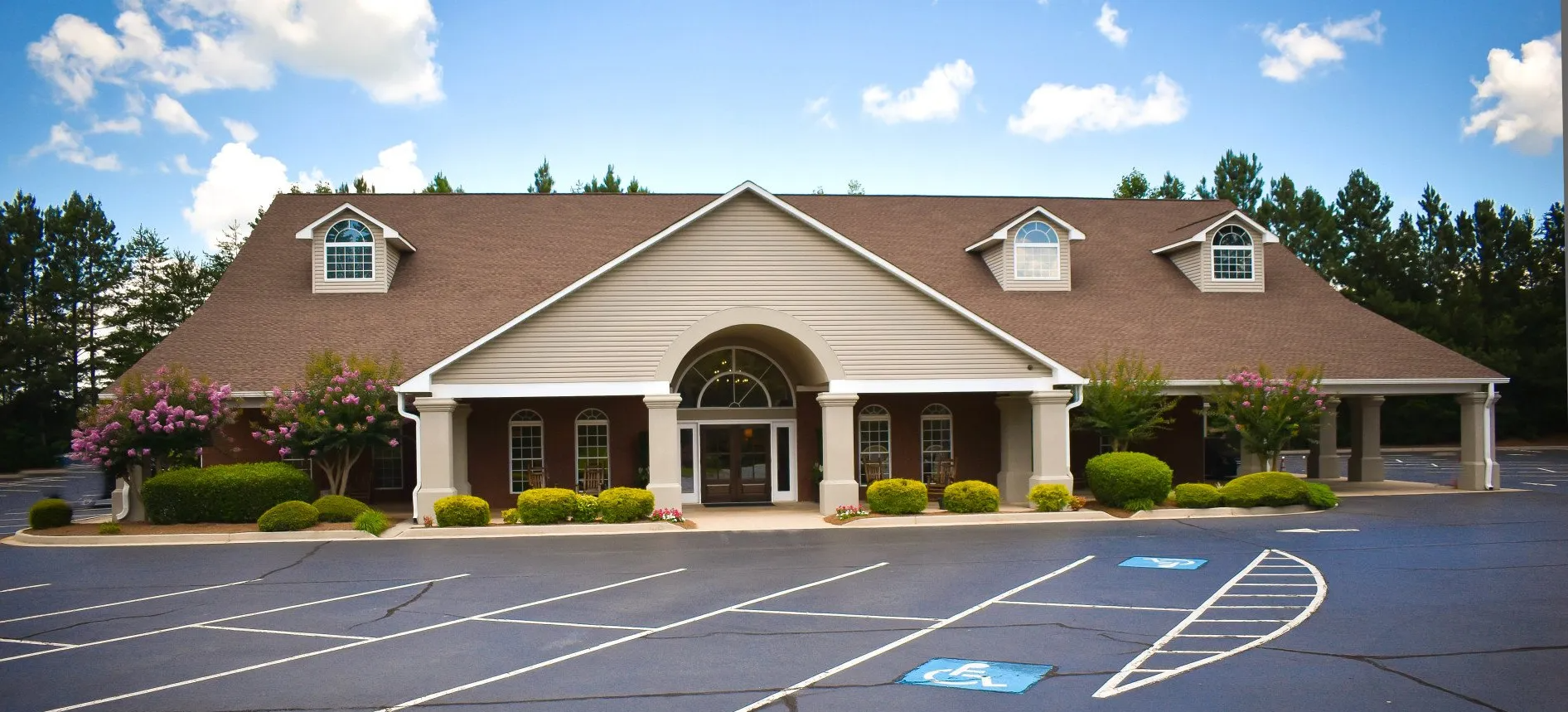 A large building with a handicapped parking spot in front of it