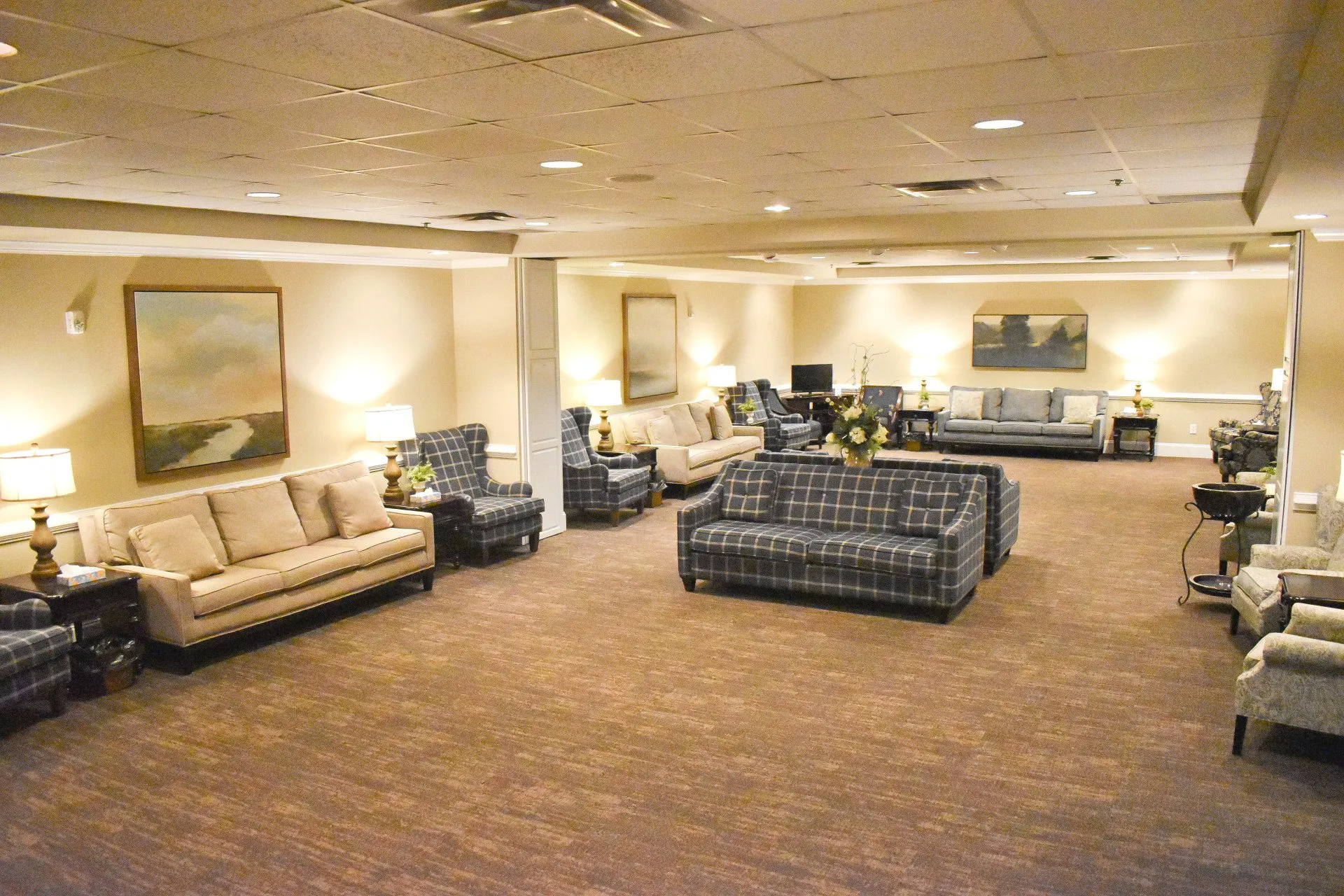 A living room with a lot of furniture and a painting on the wall