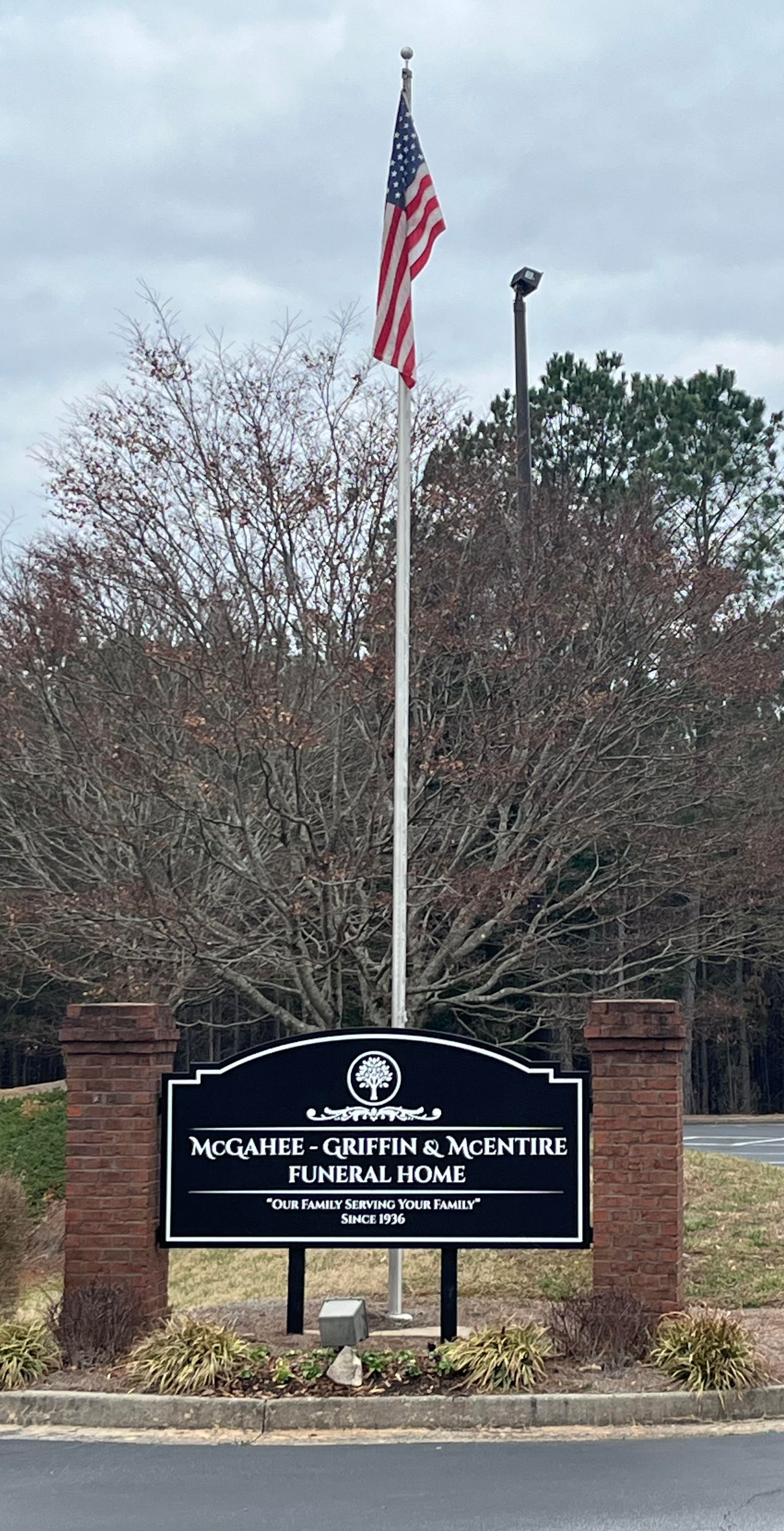 A flag is flying over a sign that says mcgahee griffin street