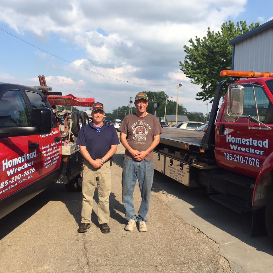 Man Fixing a Towed Car — Junction City, KS — Homestead Tow Service Man Fixing a Towed Car — Junction City, KS — Homestead Tow Service