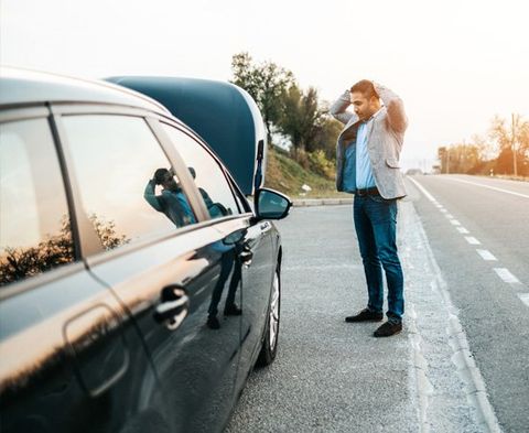 Man with Broken Car Beside a Road — Junction City, KS — Homestead Tow Service