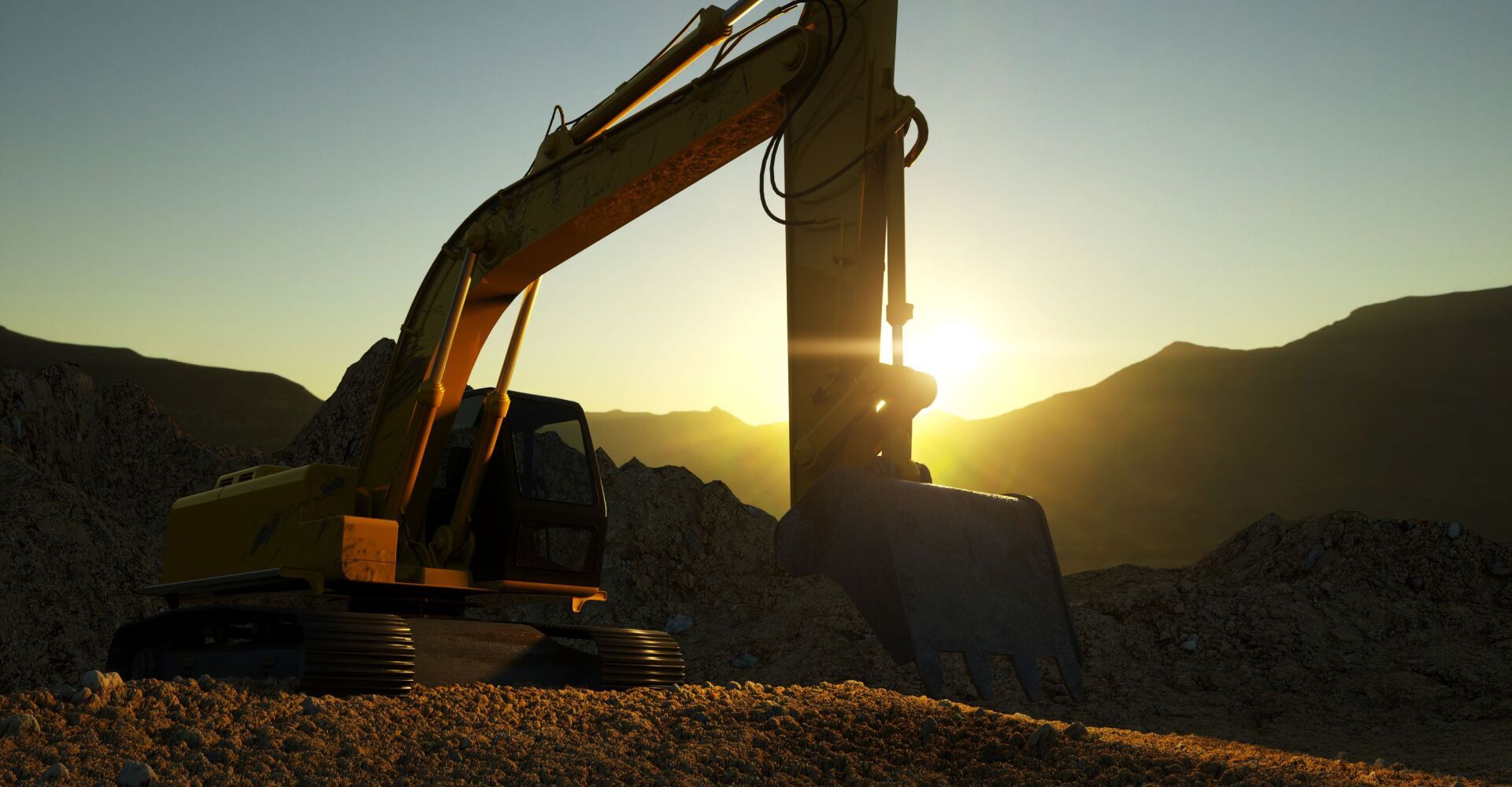 A yellow excavator is sitting on top of a pile of gravel at sunset.