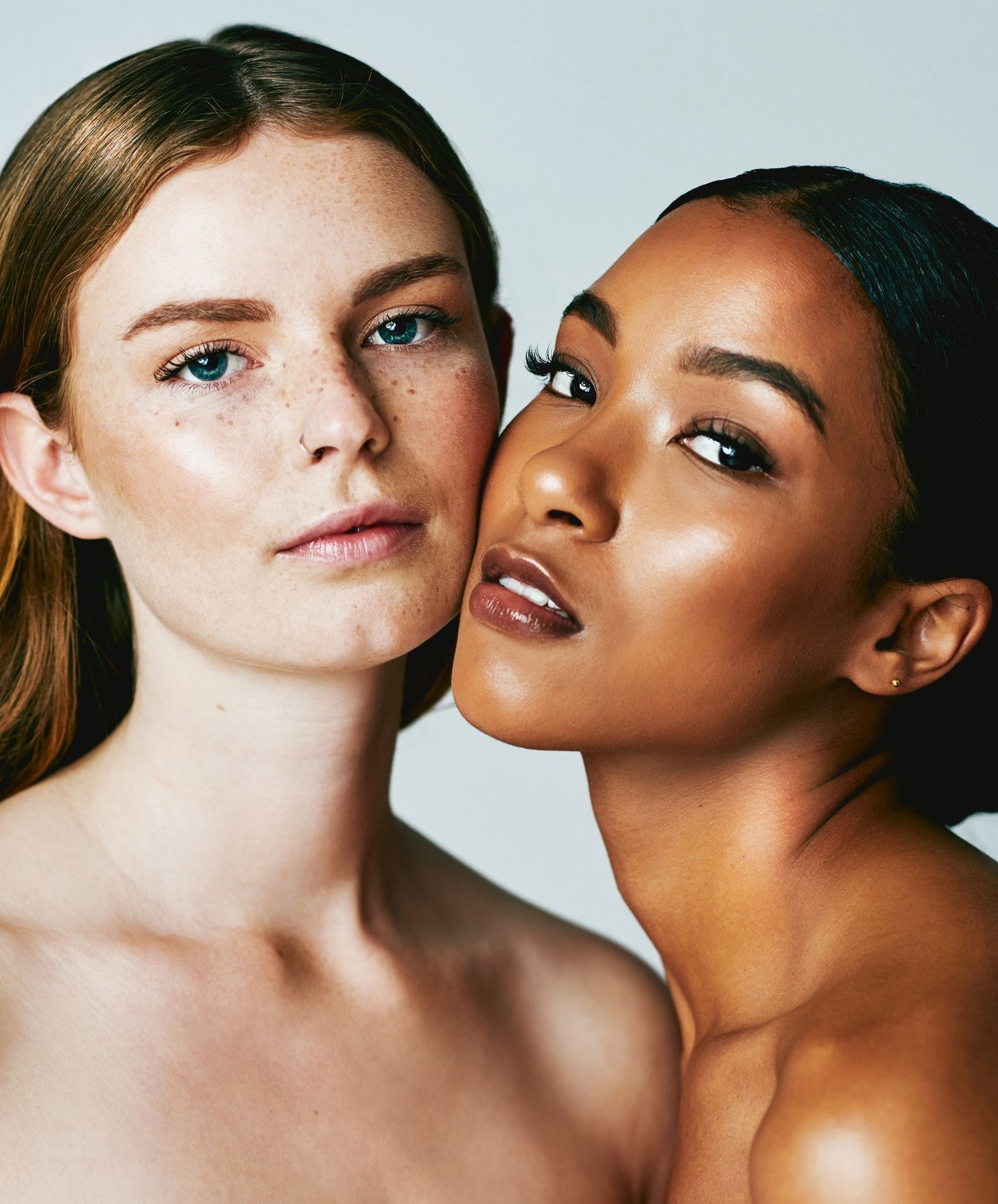 Two women are standing next to each other and looking at the camera.
