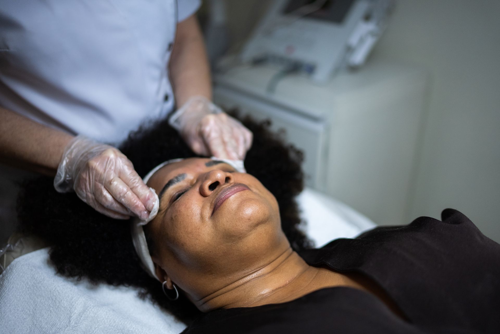A woman is getting a facial treatment at a spa.